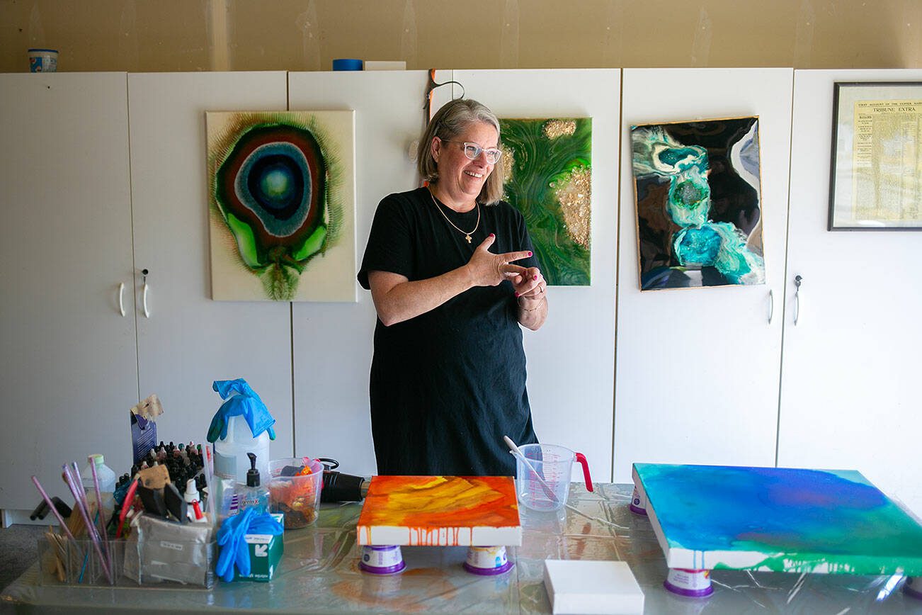 Artist Michelle Downes prepares to work on a few canvases in her garage workspace on Thursday, July 6, 2023, at her family’s home in Stanwood, Washington. (Ryan Berry / The Herald)