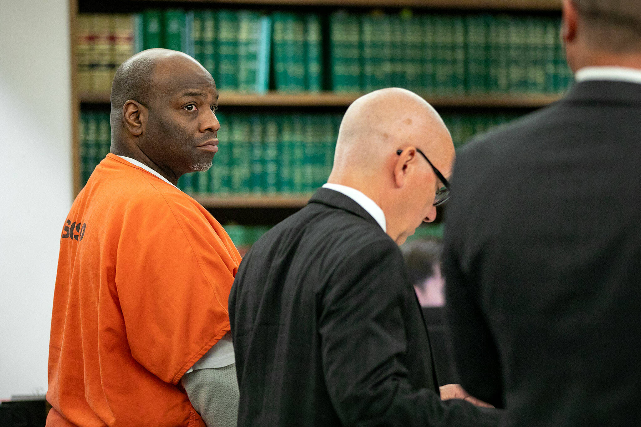 Antonial Monroe, left, alongside defense attorney Donald Wackerman, center, looks over at prosecuting attorney Matt Hunter as Hunter addresses the court during Monroe’s sentencing hearing Thursday, Oct. 5, 2023, at Snohomish County Superior Court in Everett, Washington. (Ryan Berry / The Herald)