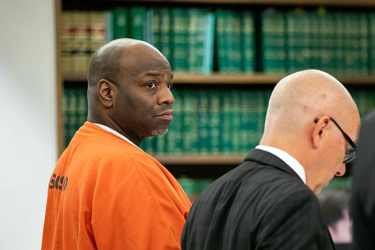 Antonial Monroe, left, alongside defense attorney Donald Wackerman, center, looks over at prosecuting attorney Matt Hunter as Hunter addresses the court during Monroe's sentencing hearing Thursday, Oct. 5, 2023, at Snohomish County Superior Court in Everett, Washington. (Ryan Berry / The Herald)