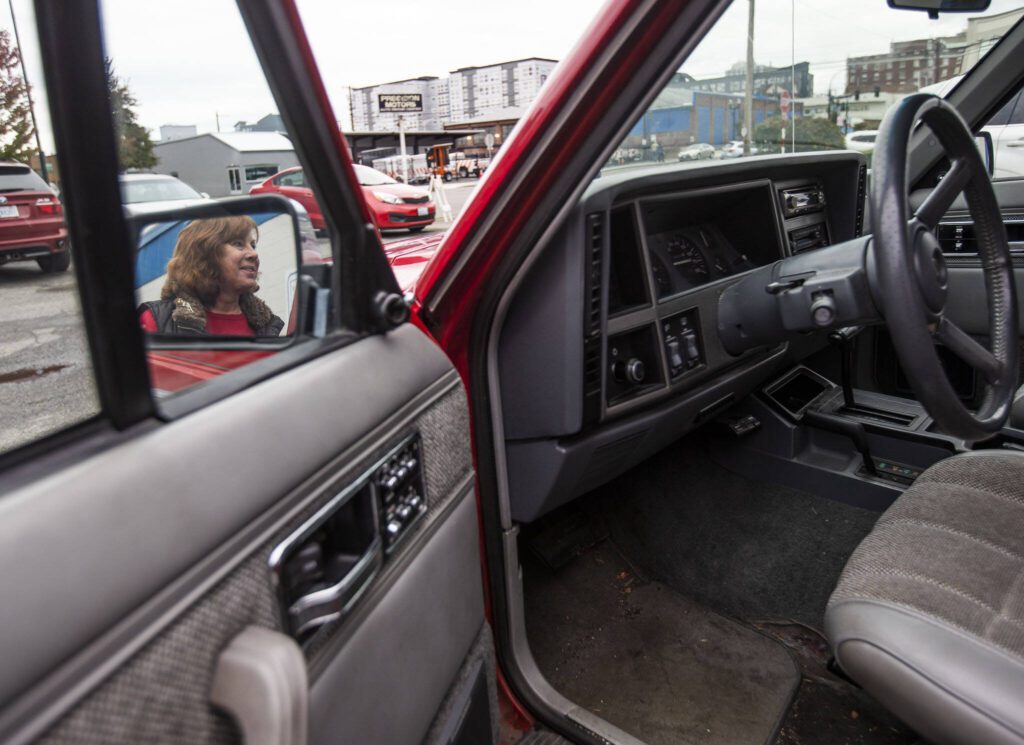 Barb Denton with her Jeep Cherokee Laredo that she calls the Red Dragon. (Olivia Vanni / The Herald)
