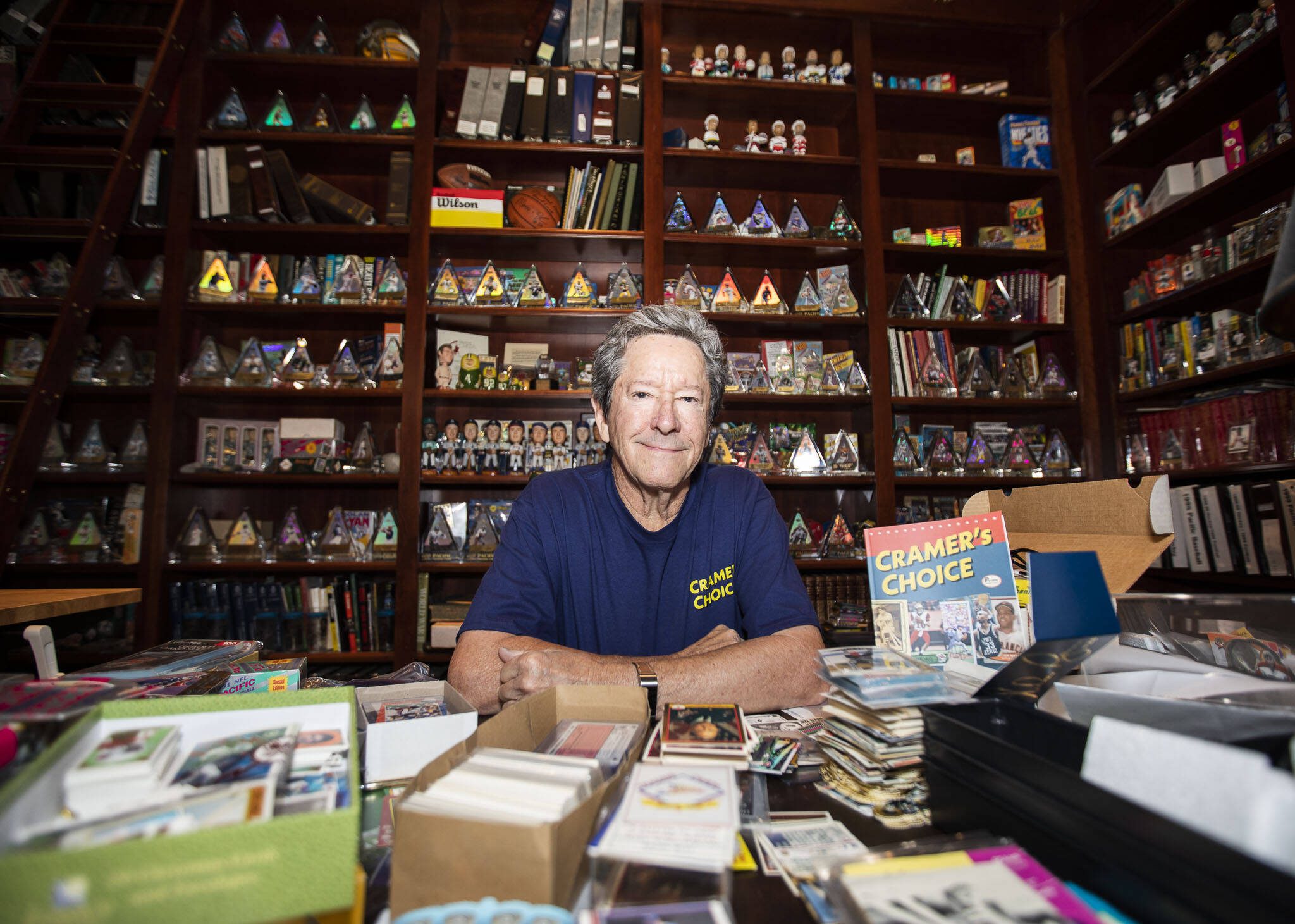 Mike Cramer, founder of Pacific Trading Cards, in his Edmonds home office filled with his sports memorabilia and card collection. He wrote a new book, “Cramer’s Choice: Memoir of a Baseball Card Collector Turned Manufacturer.” (Olivia Vanni / The Herald)