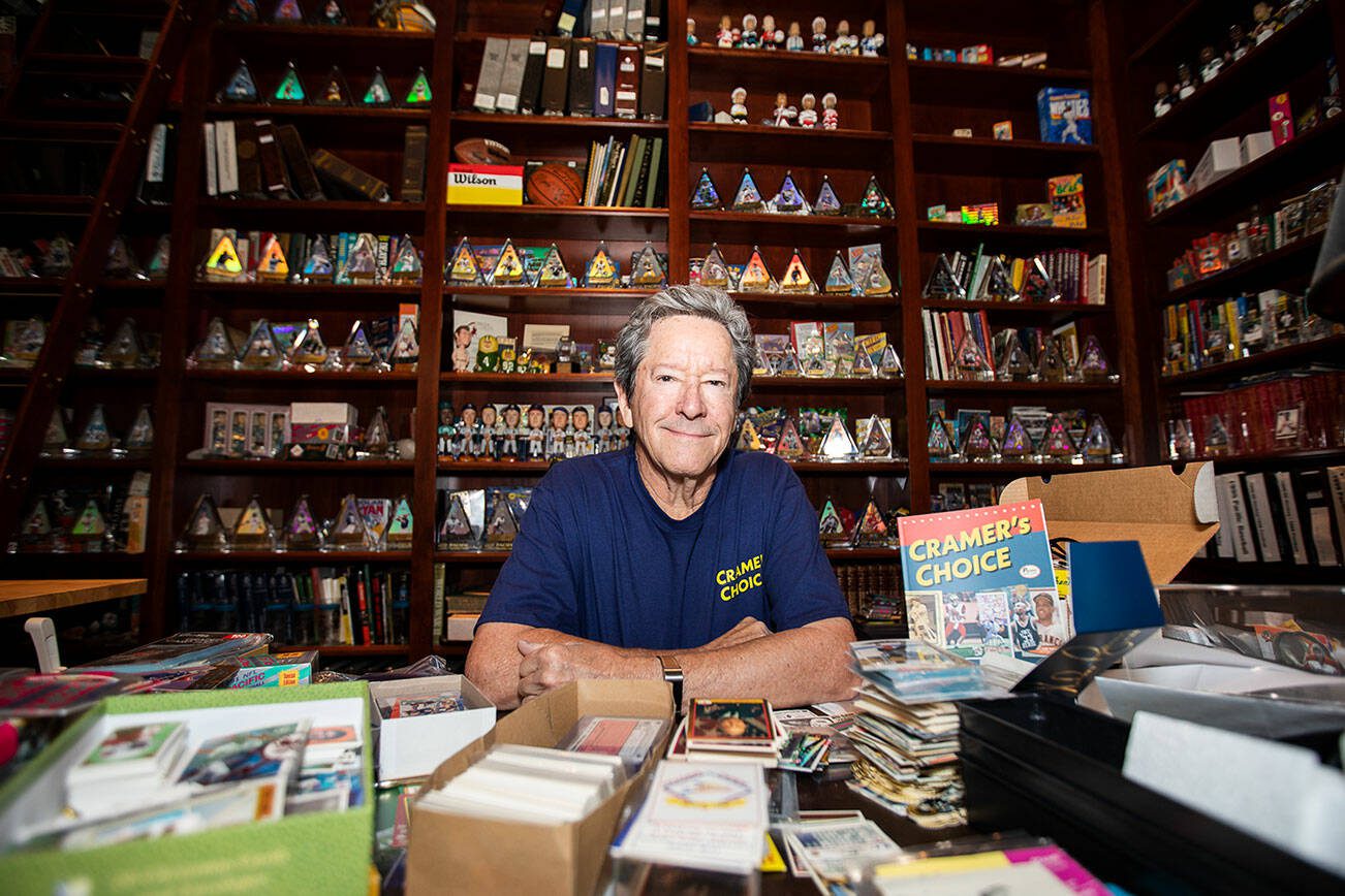 Mike Cramer in his home office filled with his sports memorabilia and card collections on Thursday, Oct. 5, 2023 in Edmonds, Washington. (Olivia Vanni / The Herald)