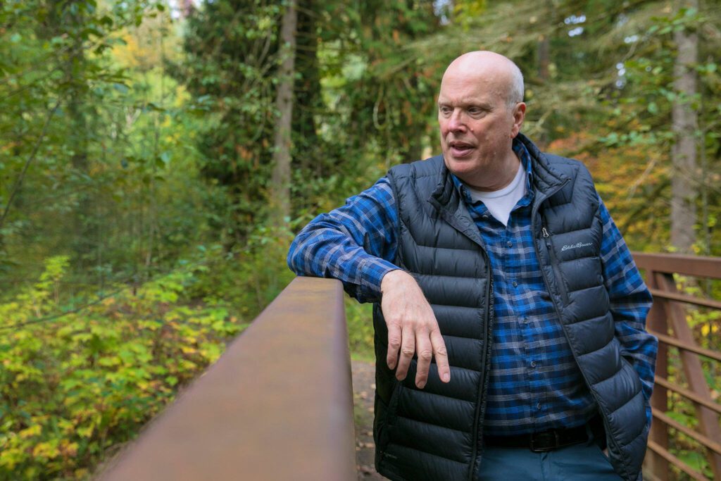 PUD Natural Resources Manager Keith Binkley leans on a bridge that spans a manmade channel at Osprey Park on Friday, Oct. 6, 2023, in Sultan, Washington. Efforts to rewild and create new habitat can help boom salmon populations. (Ryan Berry / The Herald)
