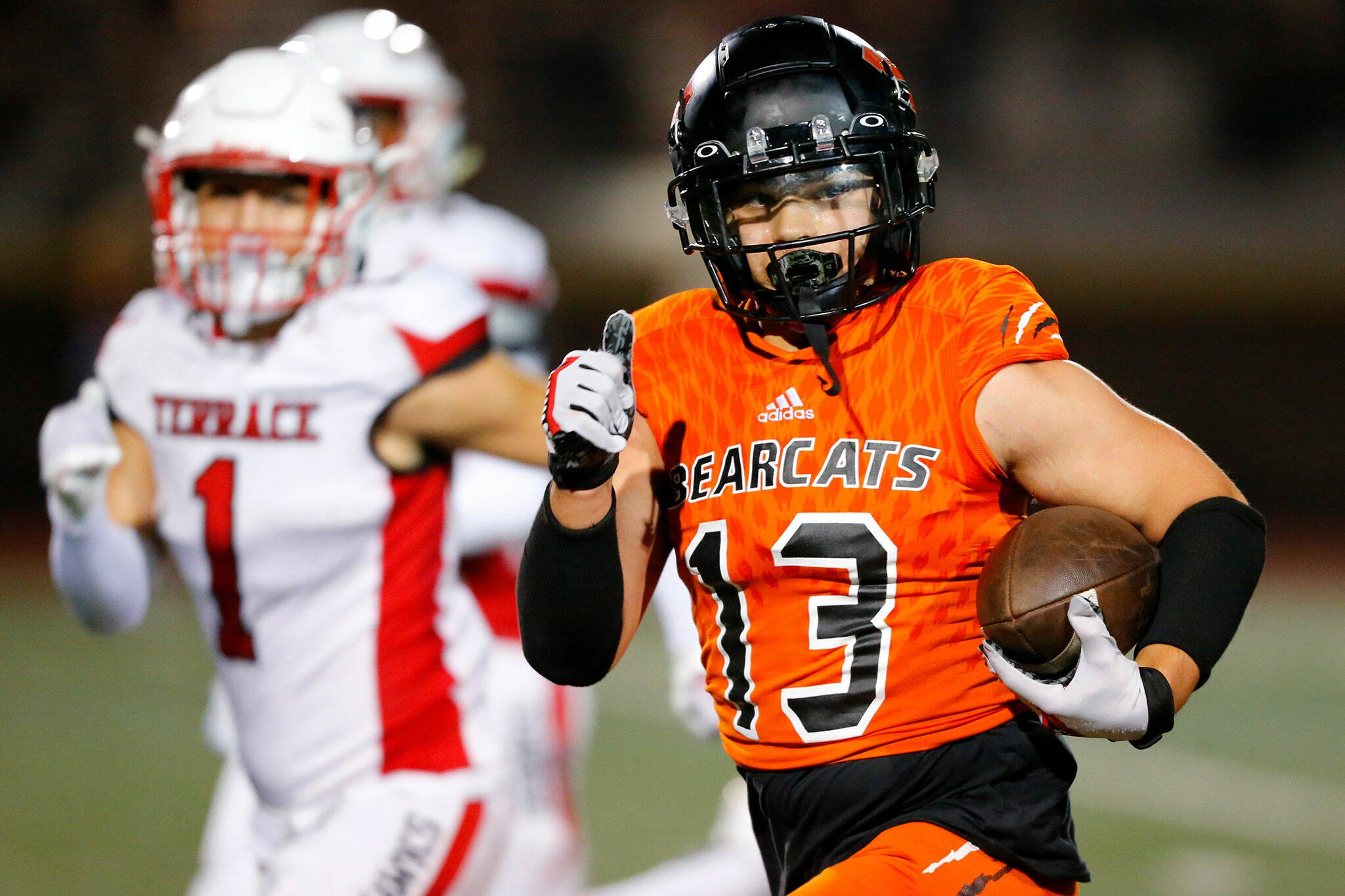 Monroe junior receiver Aaron Clifton checks for defenders while taking a long reception to the house during a game against Mountlake Terrace on Sept. 29 at Monroe High School. (Ryan Berry / The Herald)