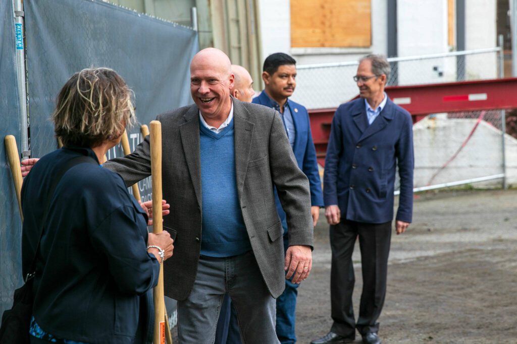 Tom Sebastian, CEO of Compass Health, joins the line to break ground with a golden shovel during a ceremony for phase two of Compass Health’s Broadway Campus Redevelopment project Thursday, Oct. 12, 2023, in Everett, Washington. (Ryan Berry / The Herald)
