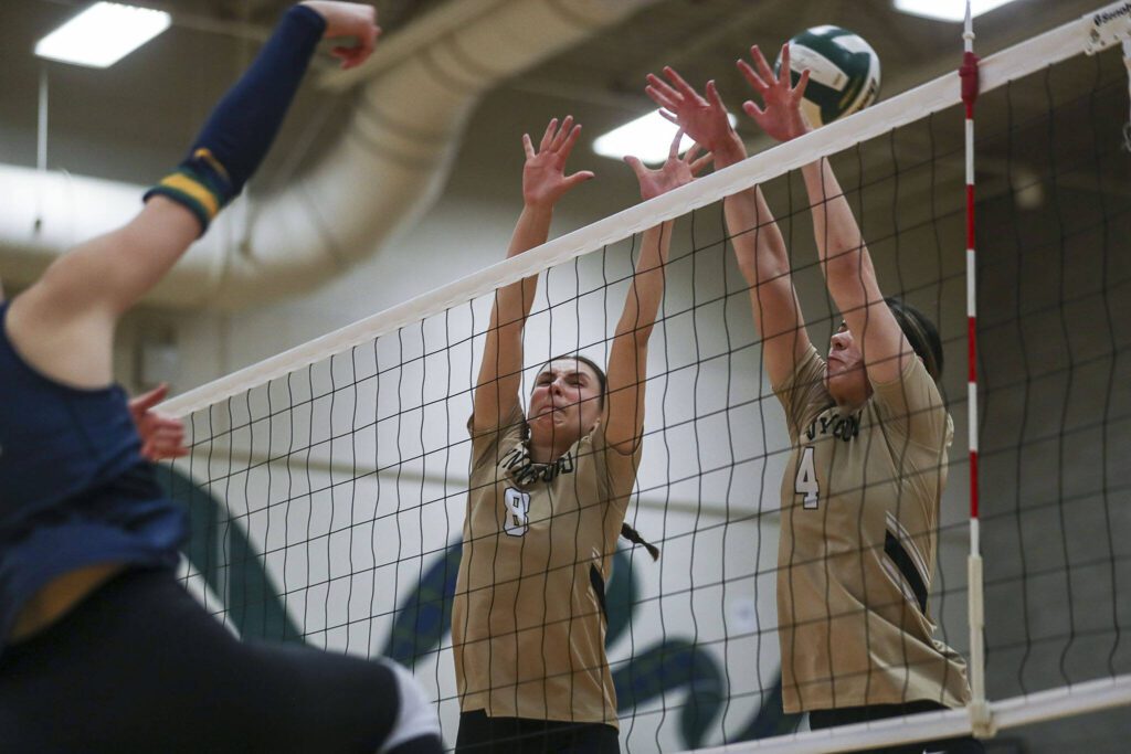 Lynnwood’s Ady Morgan (8) and Abbie Orr (4) move to block during a volleyball game between Lynnwood and Shorecrest at Shorecrest High School in Shoreline, Washington on Tuesday, Oct. 3, 2023. Lynnwood took the win. (Annie Barker / The Herald)
