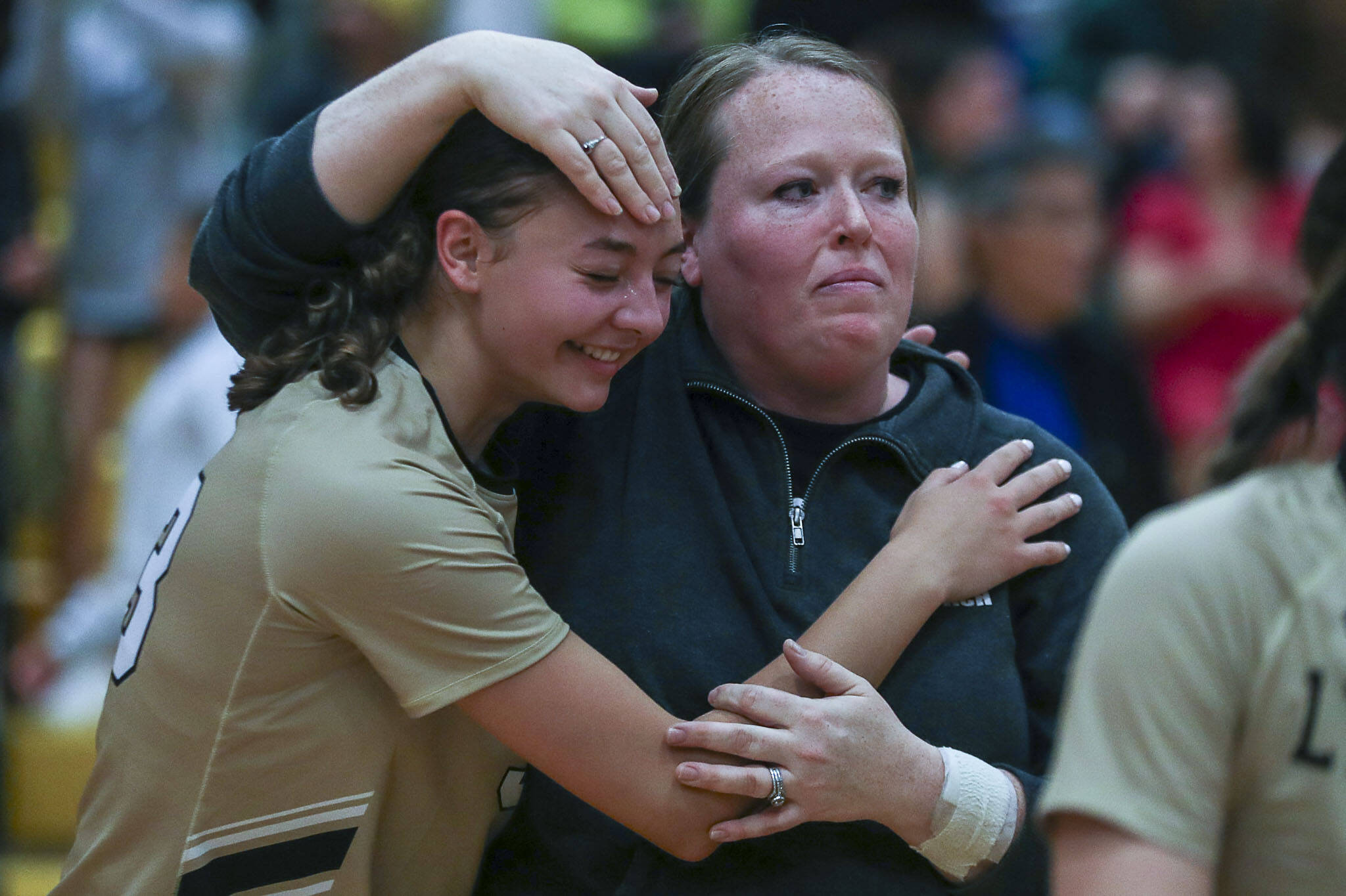 Lynnwood players and head coach Annalise Mudaliar celebrate during a volleyball game between Lynnwood and Shorecrest at Shorecrest High School in Shoreline, Washington on Tuesday, Oct. 3, 2023. Lynnwood took the win. (Annie Barker / The Herald)