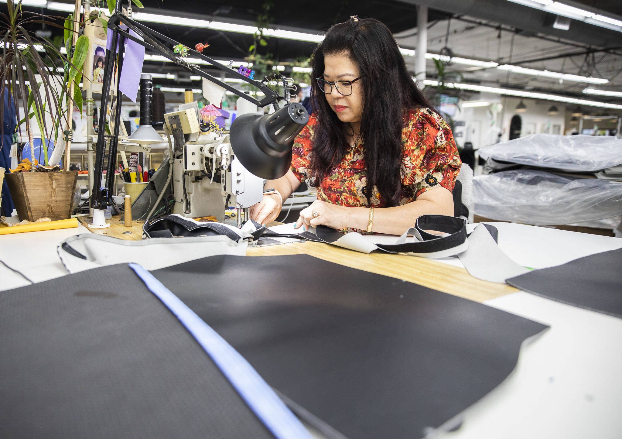 My Luu Dau works on stitching a product at Kaas Tailored on Tuesday, Oct. 10, 2023 in Mukilteo, Washington. (Olivia Vanni / The Herald)