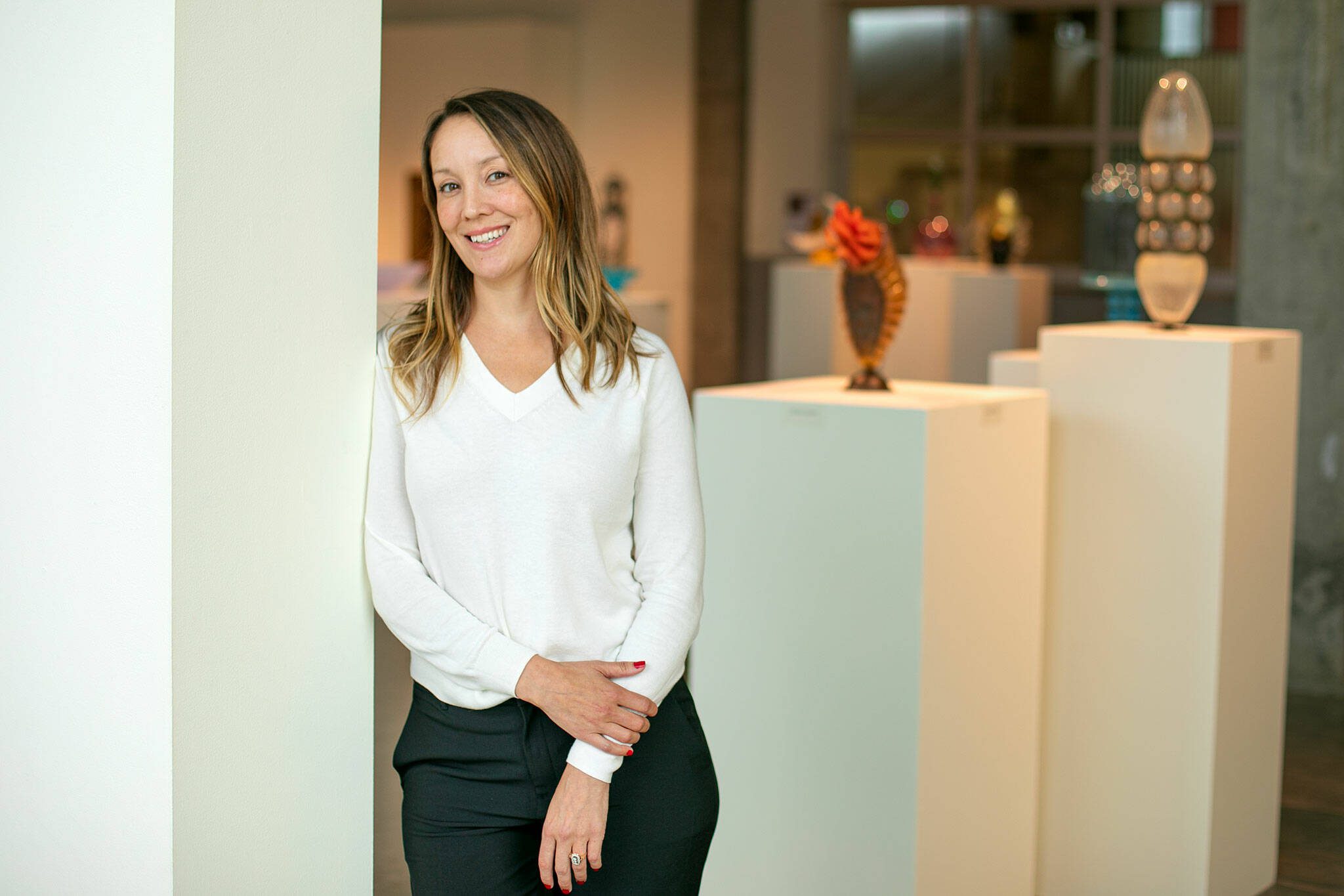 Raedle Alburn, the development and education director at Schack Art Center, stands in the Schack’s main gallery in Everett. Alburn is one of six recipients of the Washington Art Education Association awards. (Ryan Berry / The Herald)