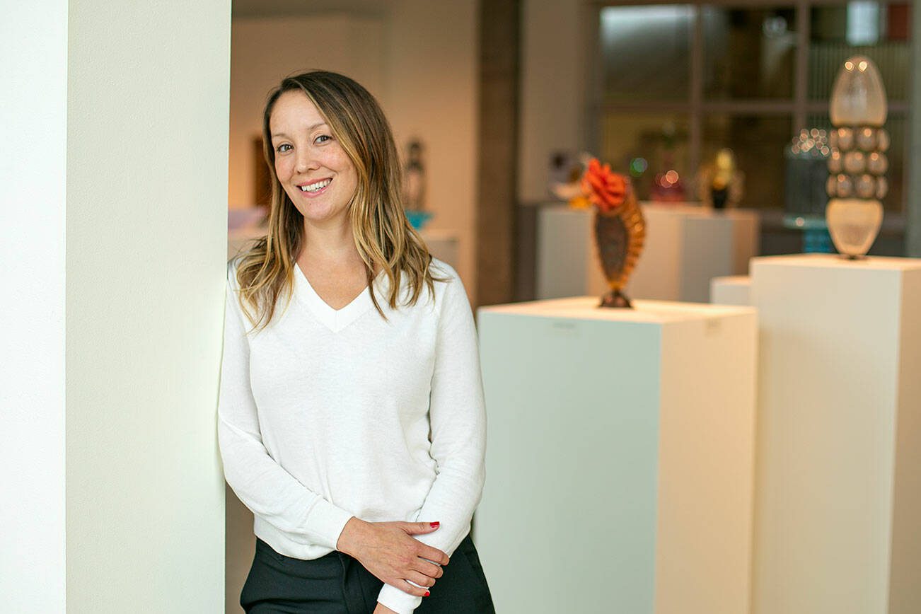 Raedle Alburn, the development and education director at Schack Art Center, stands in the Schack’s main gallery Thursday, Oct. 19, 2023, in Everett, Washington. Alburn is one of six recipients of the Washington Art Education Association award. (Ryan Berry / The Herald)