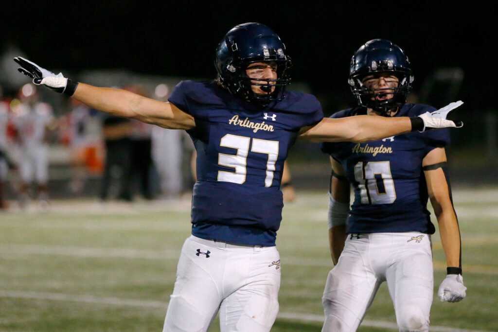Arlington senior Kobi Spady celebrates breaking up a pass against Marysville Pilchuck on Friday, Oct. 6, 2023, at Arlington High School in Arlington, Washington. (Ryan Berry / The Herald)
