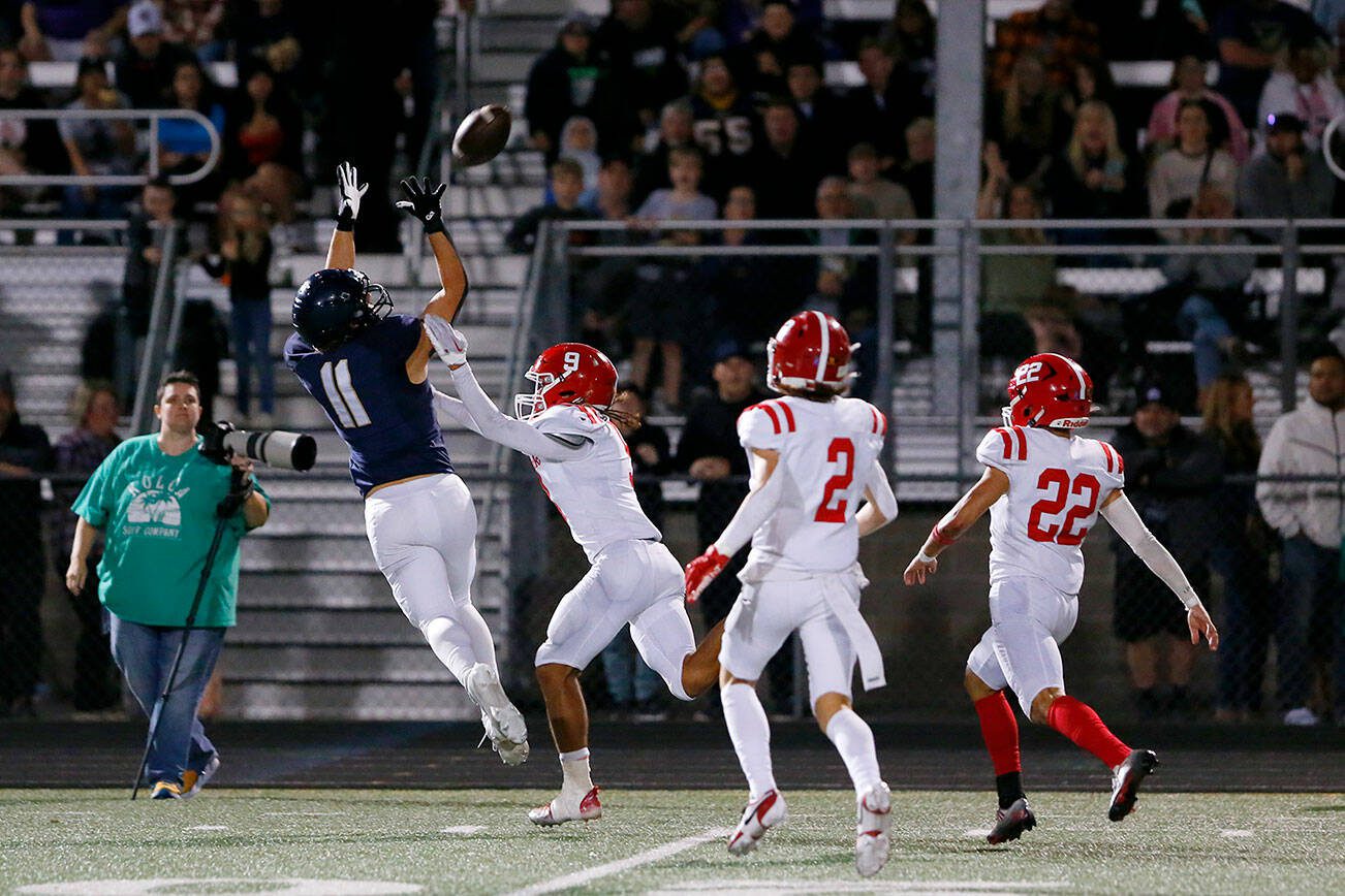 Arlington’s Jeremy Fleming comes down with the ball, but barely out of bounds, against Marysville Pilchuck on Friday, Oct. 6, 2023, at Arlington High School in Arlington, Washington. (Ryan Berry / The Herald)