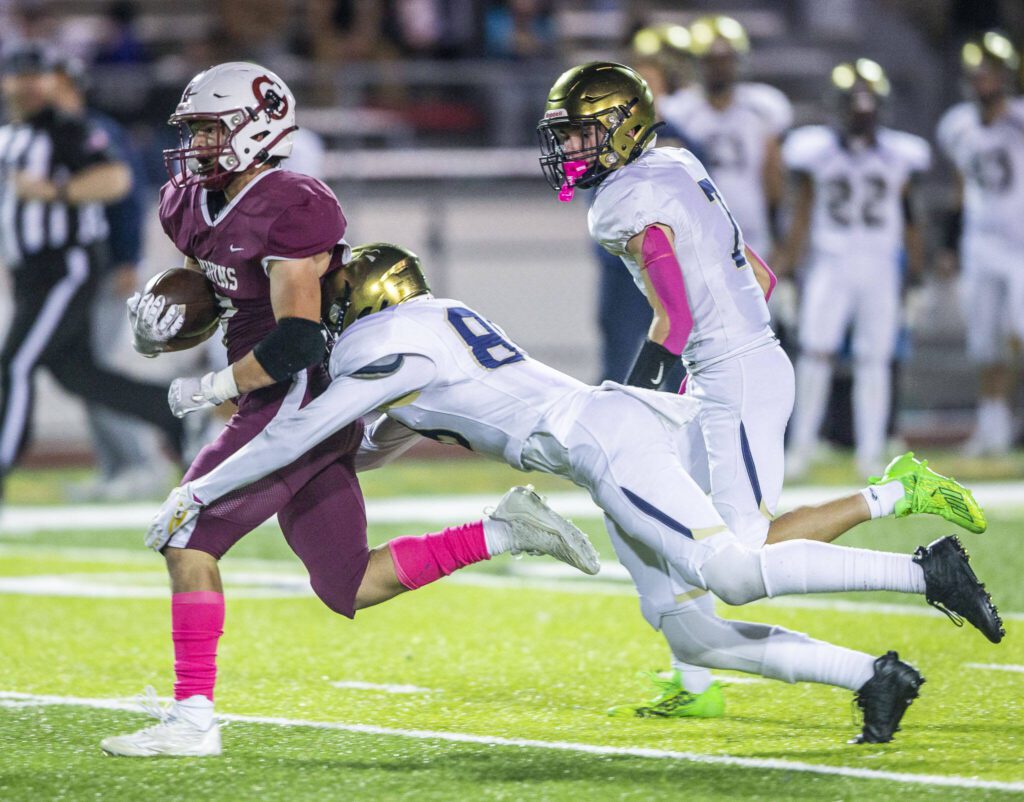 Cascade’s Zach Lopez is tackled by Everett’s Bryce Campbell during the game on Friday, Oct. 6, 2023 in Everett, Washington. (Olivia Vanni / The Herald)
