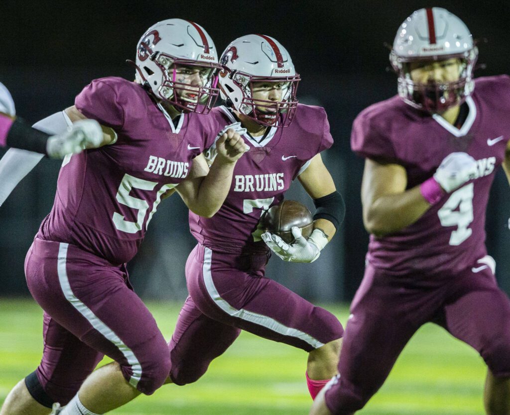 Cascade’s Zach Lopez looks for an opening while running the ball during the game against Everett on Friday, Oct. 6, 2023 in Everett, Washington. (Olivia Vanni / The Herald)
