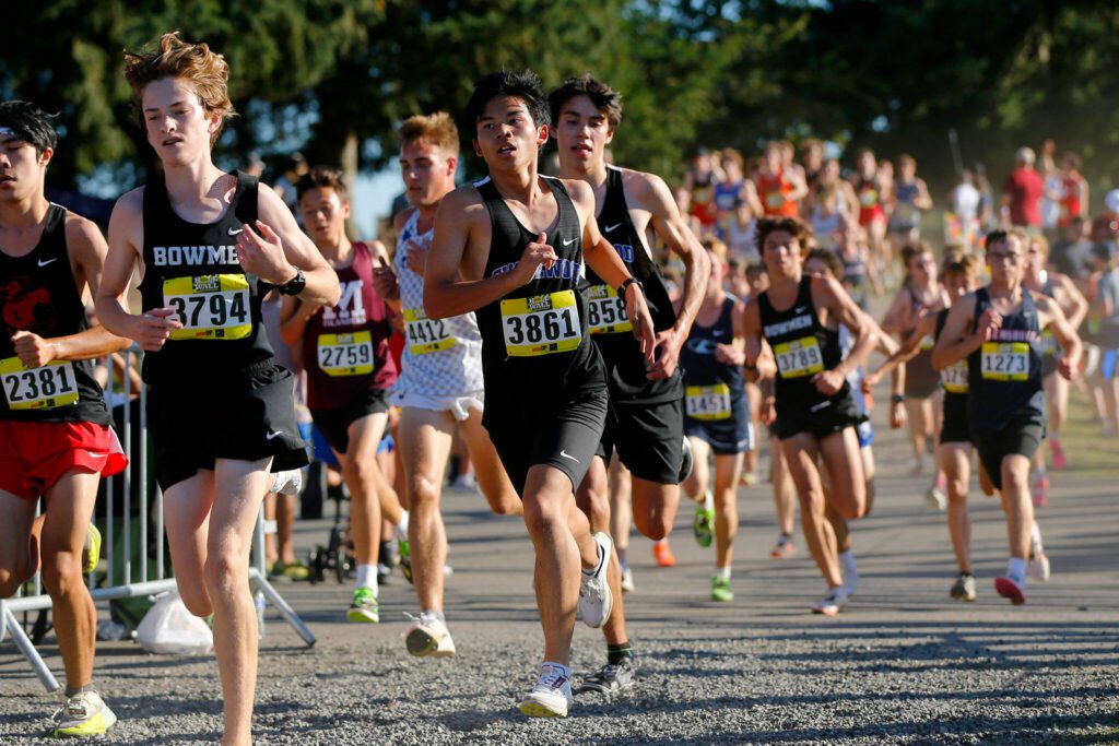 A pair of Shorewood athletes run in the Men’s Elite event during the Hole in the Wall Cross Country Invitational on Saturday, Oct. 7, 2023, at Lakewood High School in Arlington, Washington. (Ryan Berry / The Herald)
