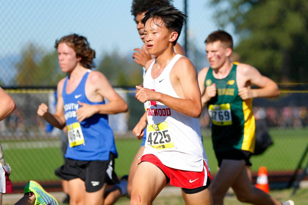 A Stanwood runner competes in the Hole in the Wall Cross Country Invitational on Saturday, Oct. 7, 2023, at Lakewood High School in Arlington, Washington. (Ryan Berry / The Herald)
