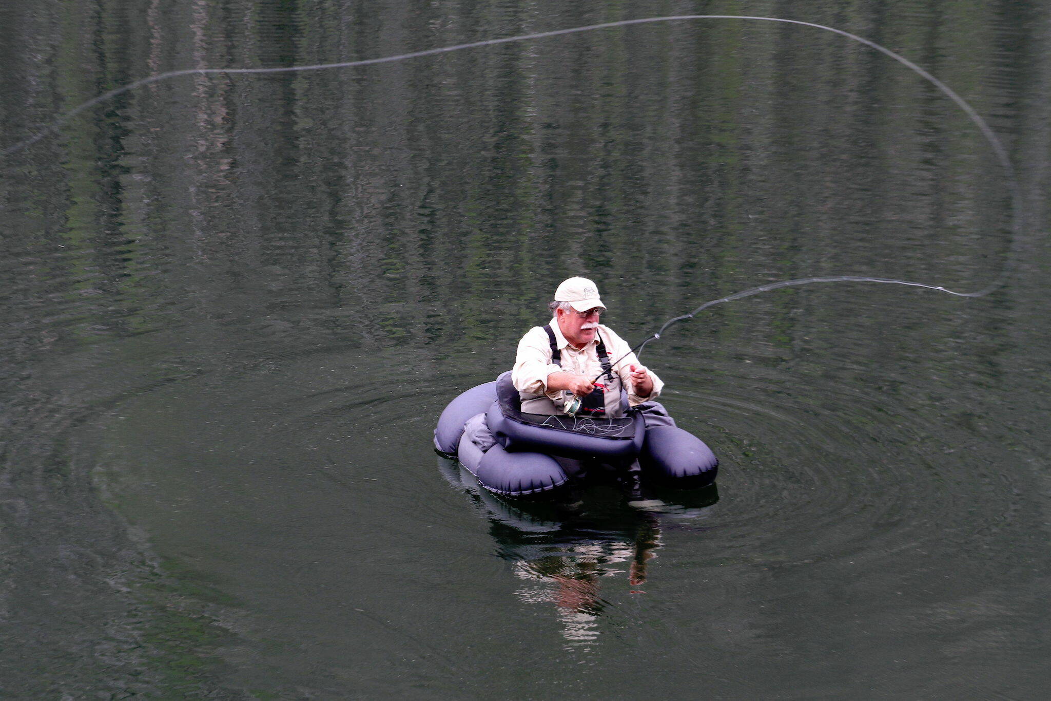 Mike Benbow, of Tulalip, uses a float tube to search for trout in Black Lake north of Winthrop in the Pasayten Wilderness at about 4,000 ft on July 20, 2012. Float tubes allow access to more water on the high mountain lakes. (Jim Haley / The Herald file)