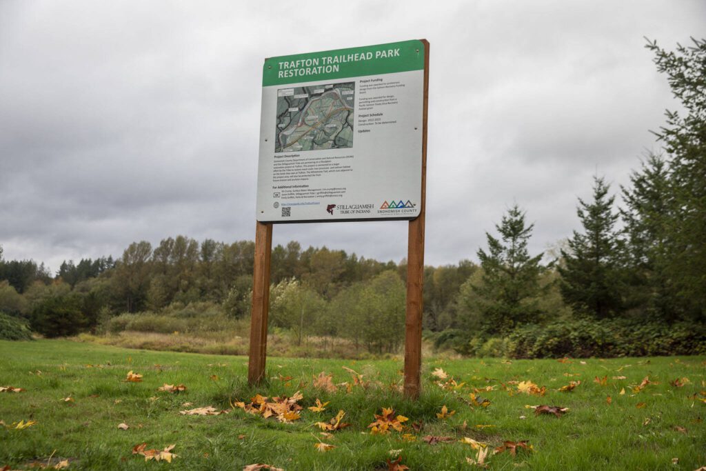 A sign off of the Whitehorse Trail displaying plants for the Trafton Trailhead Park restoration on Monday, Oct. 16, 2023 in Arlington, Washington. (Olivia Vanni / The Herald)
