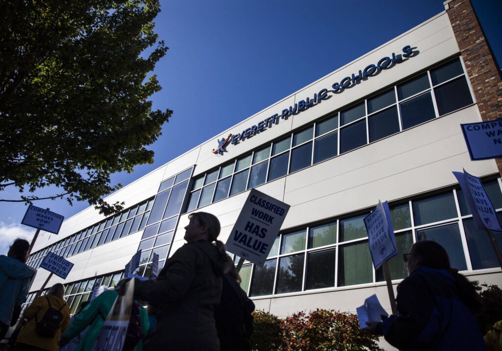 Everett Public Schools paraeducators protest outside of the Everett School Board meeting on Tuesday, Oct. 10, 2023 in Everett, Washington. (Olivia Vanni / The Herald)
