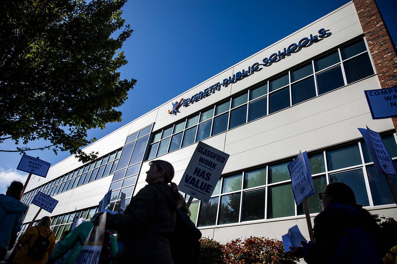 Everett Public Schools paraeducators protest outside of the Everett School Board meeting on Tuesday, Oct. 10, 2023 in Everett, Washington. (Olivia Vanni / The Herald)