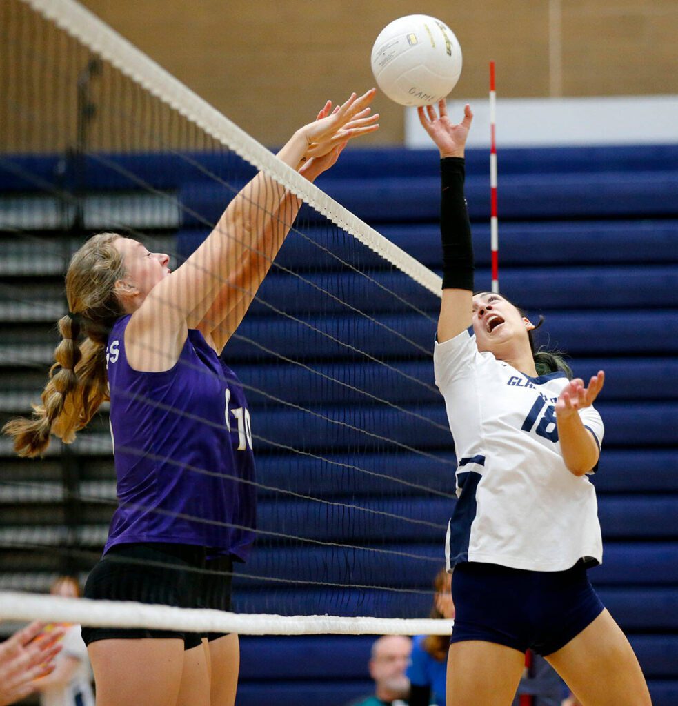 Glacier Peak’s Lucy Cornelius tries to tip the ball past two Lake Stevens blockers on Tuesday, Oct. 10, 2023, at Glacier Peak High School in Snohomish, Washington. The point was replayed after protest over the call. (Ryan Berry / The Herald)
