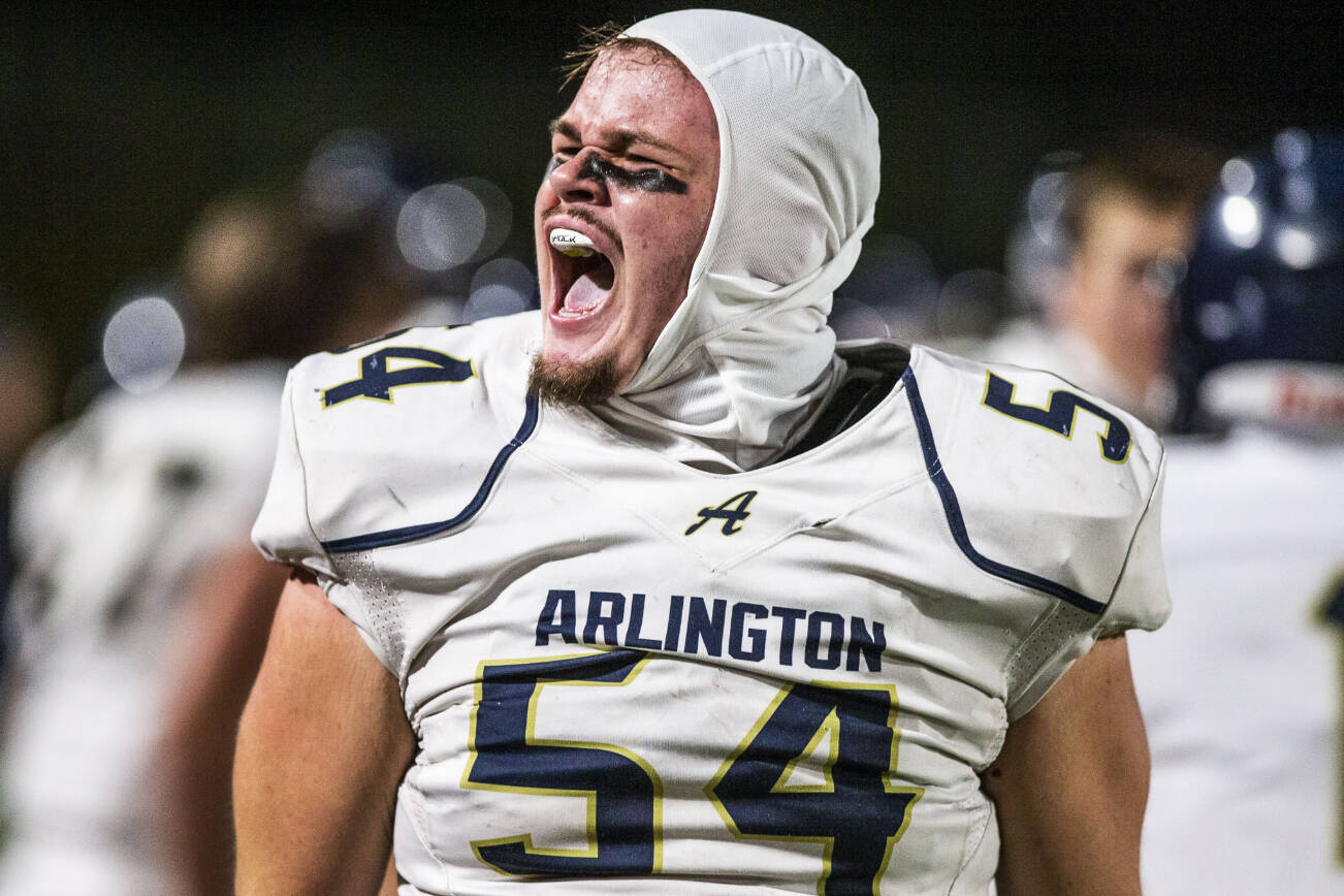 Arlington's Nolan Welch-Downing yells after forcing a turnover during the game against Stanwood on Friday, Sept. 29, 2023 in Stanwood, Washington. (Olivia Vanni / The Herald)