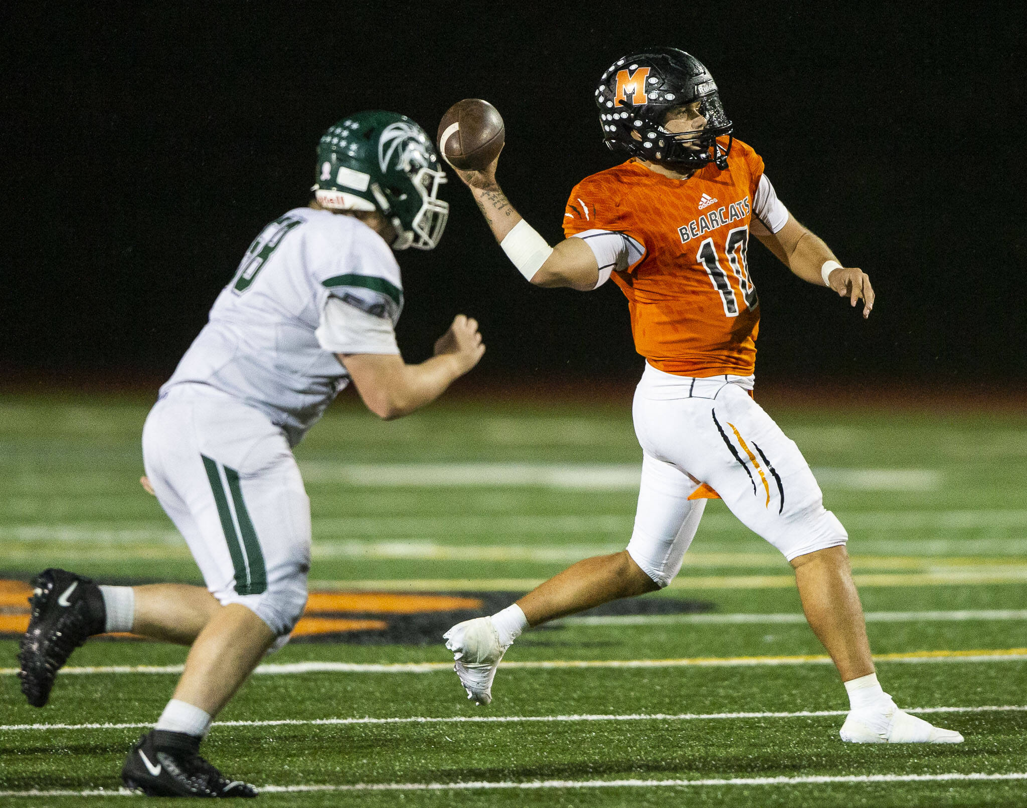 Monroe’s Blake Springer is chased by Edmonds-Woodway’s Sebastian Schuler while trying to throw the ball during the game on Friday in Monroe. (Olivia Vanni / The Herald)