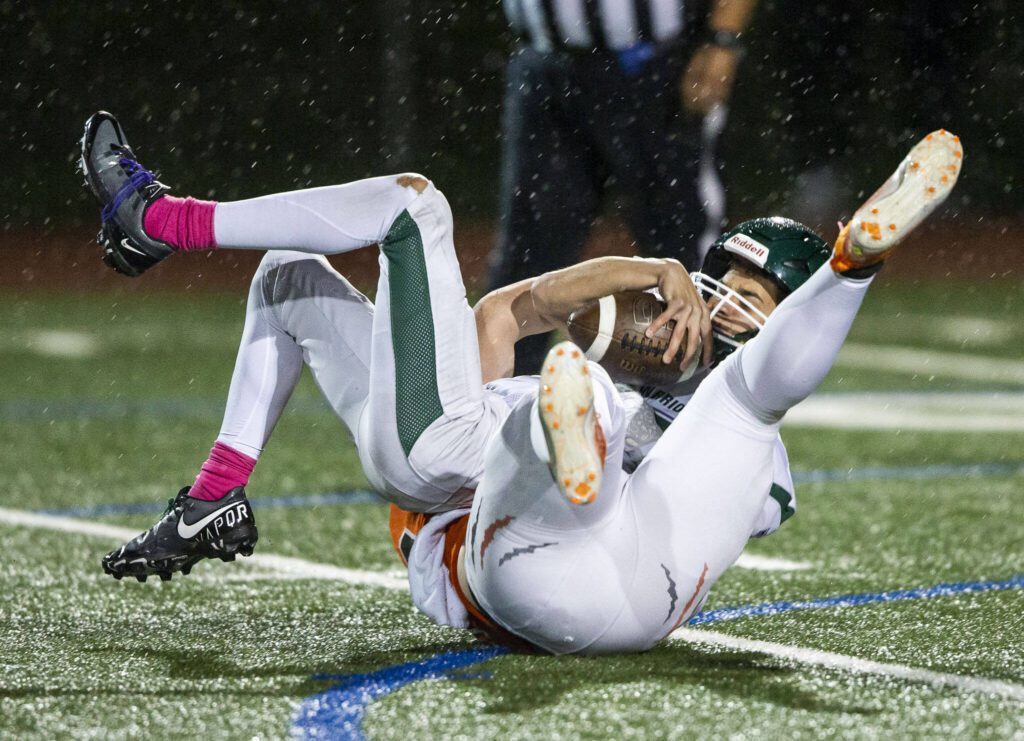 Edmonds-Woodway’s Steven Warren is sacked during the game against Monroe on Friday, Oct. 13, 2023 in Monroe, Washington. (Olivia Vanni / The Herald)
