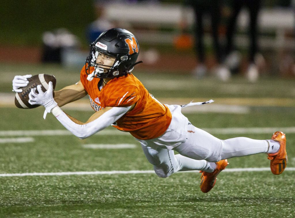 Monroe’s Mathew Rodriguez makes a diving leap to try and catch a pass during the game against Edmonds-Woodway on Friday, Oct. 13, 2023 in Monroe, Washington. (Olivia Vanni / The Herald)
