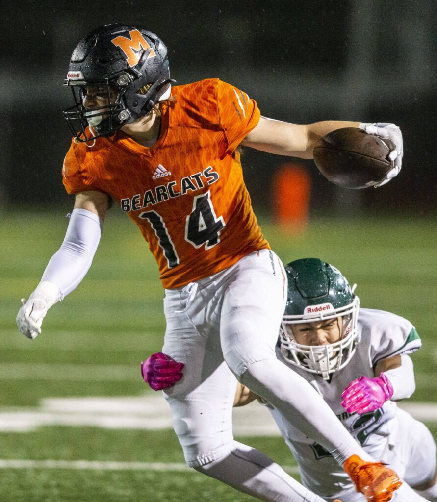 Monroe’s Ryan Miller tries to run through a tackle during the game against Edmonds-Woodway on Friday, Oct. 13, 2023 in Monroe, Washington. (Olivia Vanni / The Herald)
