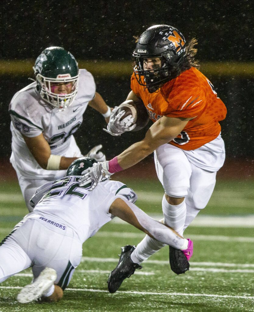 Monroe’s Nicholas Mouser escapes a tackle by Edmonds-Woodway’s Krys Piechocinski during the game on Friday, Oct. 13, 2023 in Monroe, Washington. (Olivia Vanni / The Herald)
