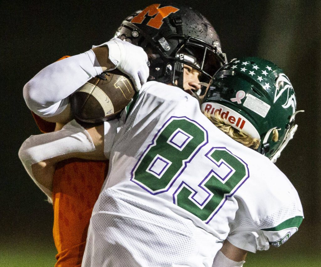 Monroe’s Jack Irwin makes a catch over the back of Edmonds-Woodway’s Lukas Wanke during the game on Friday, Oct. 13, 2023 in Monroe, Washington. (Olivia Vanni / The Herald)
