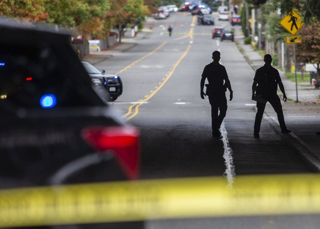 Everett police officers survey the scene of a shooting along East Casino Road on Friday, Oct. 13, 2023 in Everett, Washington. (Olivia Vanni / The Herald)
