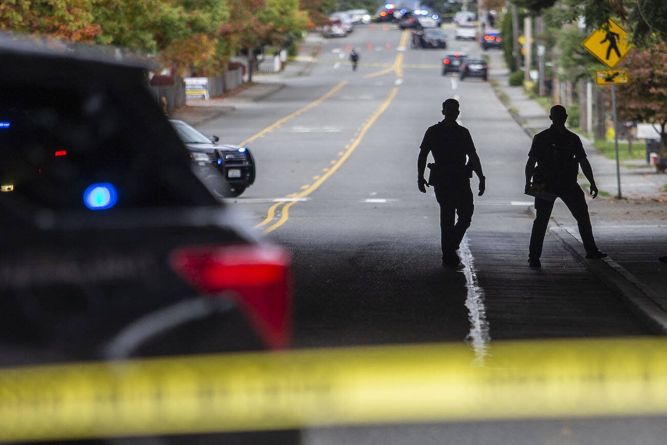 Everett police officers survey the scene of a shooting along East Casino Road on Friday, Oct. 13, 2023 in Everett, Washington. (Olivia Vanni / The Herald)