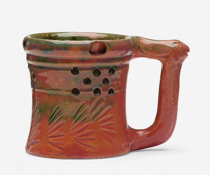 George E. Ohr’s pottery can be recognized by its thin clay, vividly colored glaze and an overall sense of eccentricity.