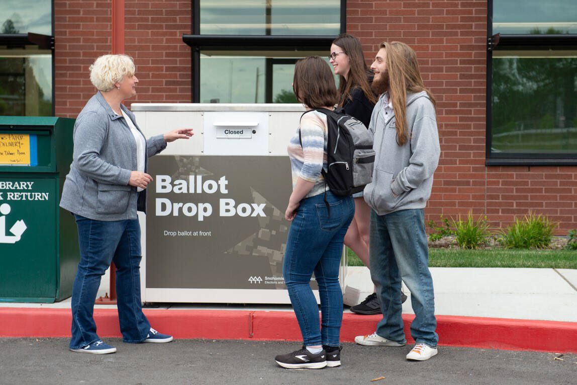 Snohomish County Auditor candidate Cindy Gobel stops to talk to people in the community at a local ballot box.