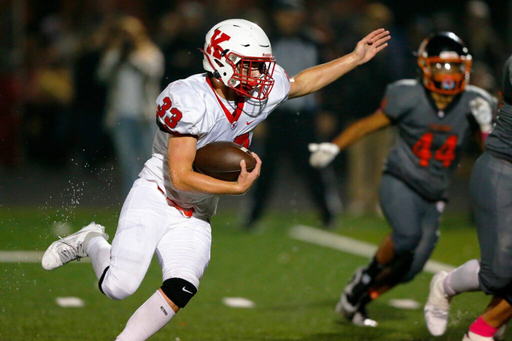 Kings freshman running back Garrett Hagen tries to cut through the line on a handoff against Granite Falls on Friday, Oct. 20, 2023, at Granite Falls High School in Granite Falls, Washington. (Ryan Berry / The Herald)
