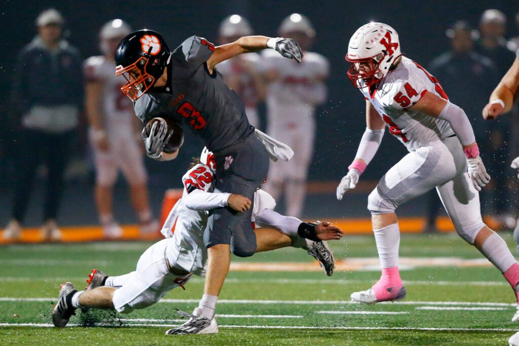 Granite Falls senior Connor Gillen gets wrapped up after collecting a few yards on a reception against Kings on Friday, Oct. 20, 2023, at Granite Falls High School in Granite Falls, Washington. (Ryan Berry / The Herald)
