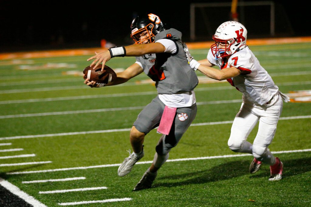 Granite Falls quarterback Kaden LaPlaunt reaches out for an extra yard on a keeper against Kings on Friday, Oct. 20, 2023, at Granite Falls High School in Granite Falls, Washington. (Ryan Berry / The Herald)

