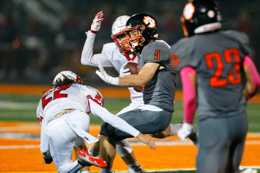 Granite Falls senior James Porter braces for a hit after making a catch against Kings on Friday, Oct. 20, 2023, at Granite Falls High School in Granite Falls, Washington. (Ryan Berry / The Herald)
