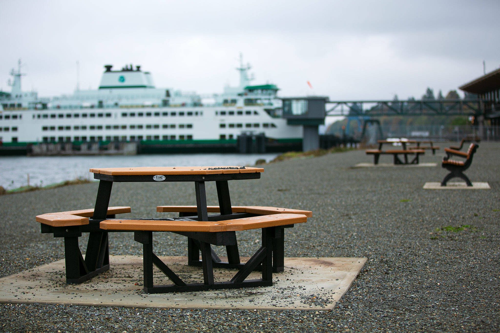 New benches and tables line the waterfront at a new park near the Mukilteo ferry terminal. (Ryan Berry / The Herald)