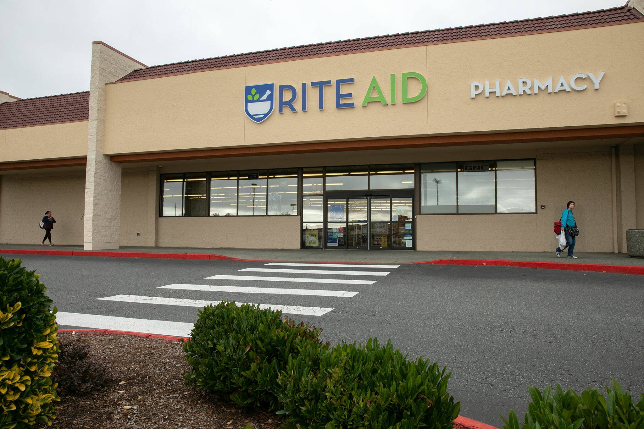 Customers come and go at a soon-to-close Rite Aid on Evergreen Way on Friday, Oct. 19, 2023, in Everett, Washington. (Ryan Berry / The Herald)