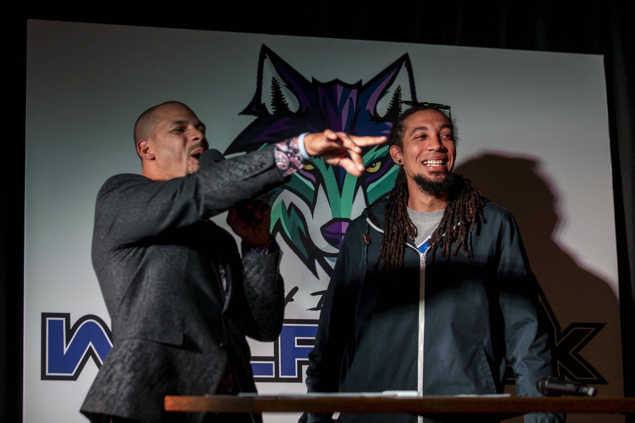 Head coach JR Wells, left, signs on JR Nelson, right, during the Everett AFL team unveiling at Tony V's Garage in Everett, Washington onThursday, Oct. 26, 2023. (Annie Barker / The Herald)