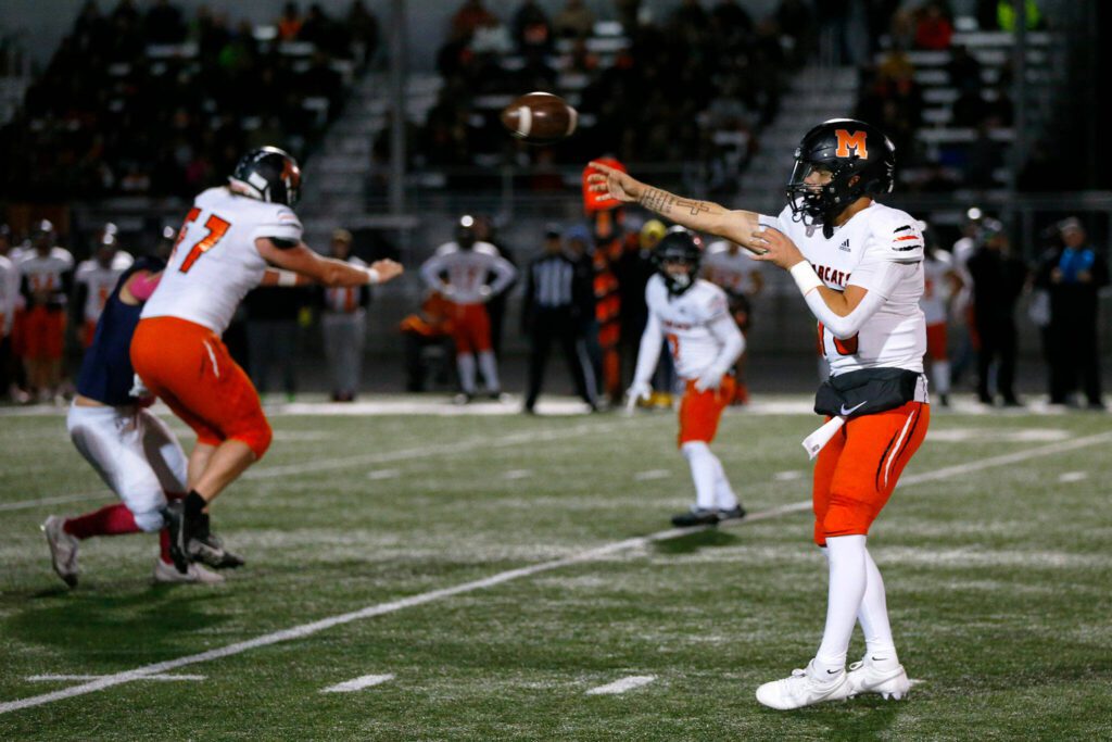 Monroe quarterback Blake Springer dumps off a screen against Arlington on Friday, Oct. 27, 2023, at Arlington High School in Arlington, Washington. (Ryan Berry / The Herald)
