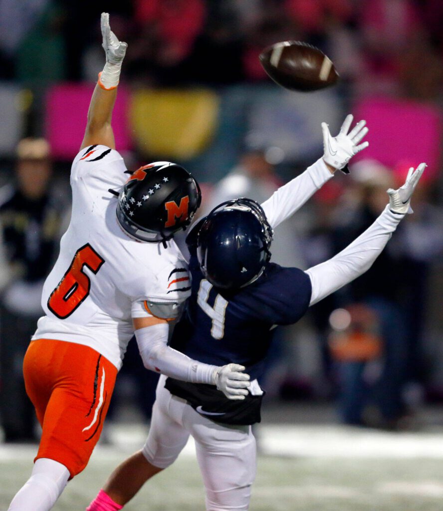 Arlington’s Jake Willis makes an impressive catch over his shoulder while being defended closely by Monroe on Friday, Oct. 27, 2023, at Arlington High School in Arlington, Washington. (Ryan Berry / The Herald)
