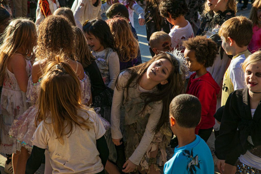 Youth contestants moan and groan during a zombie-off during the 10th annual Snohomish Zombie Walk on Saturday, Oct. 28, 2023, in downtown Snohomish, Washington. (Ryan Berry / The Herald)
