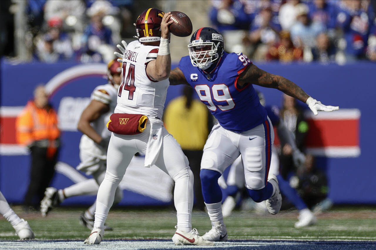 New York Giants defensive end Leonard Williams (99) sacks Washington Commanders quarterback Sam Howell (14) during a game Sunday in East Rutherford, N.J. (AP Photo/Adam Hunger)