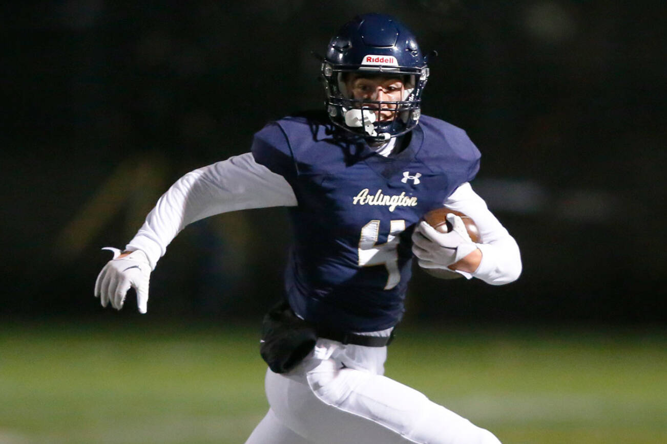 Arlington junior Jake Willis takes a kickoff for a long return against Monroe on Friday, Oct. 27, 2023, at Arlington High School in Arlington, Washington. (Ryan Berry / The Herald)