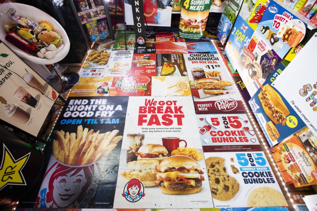 Fast-food signs cover the floor of the Snackin Shack. (Olivia Vanni / The Herald)
