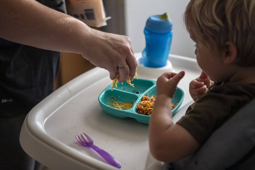 Stephanie Boyle prepares dinner for her three children at their new apartment in Marysville, Washington, on Thursday, Sept. 14, 2023. (Annie Barker / The Herald)
